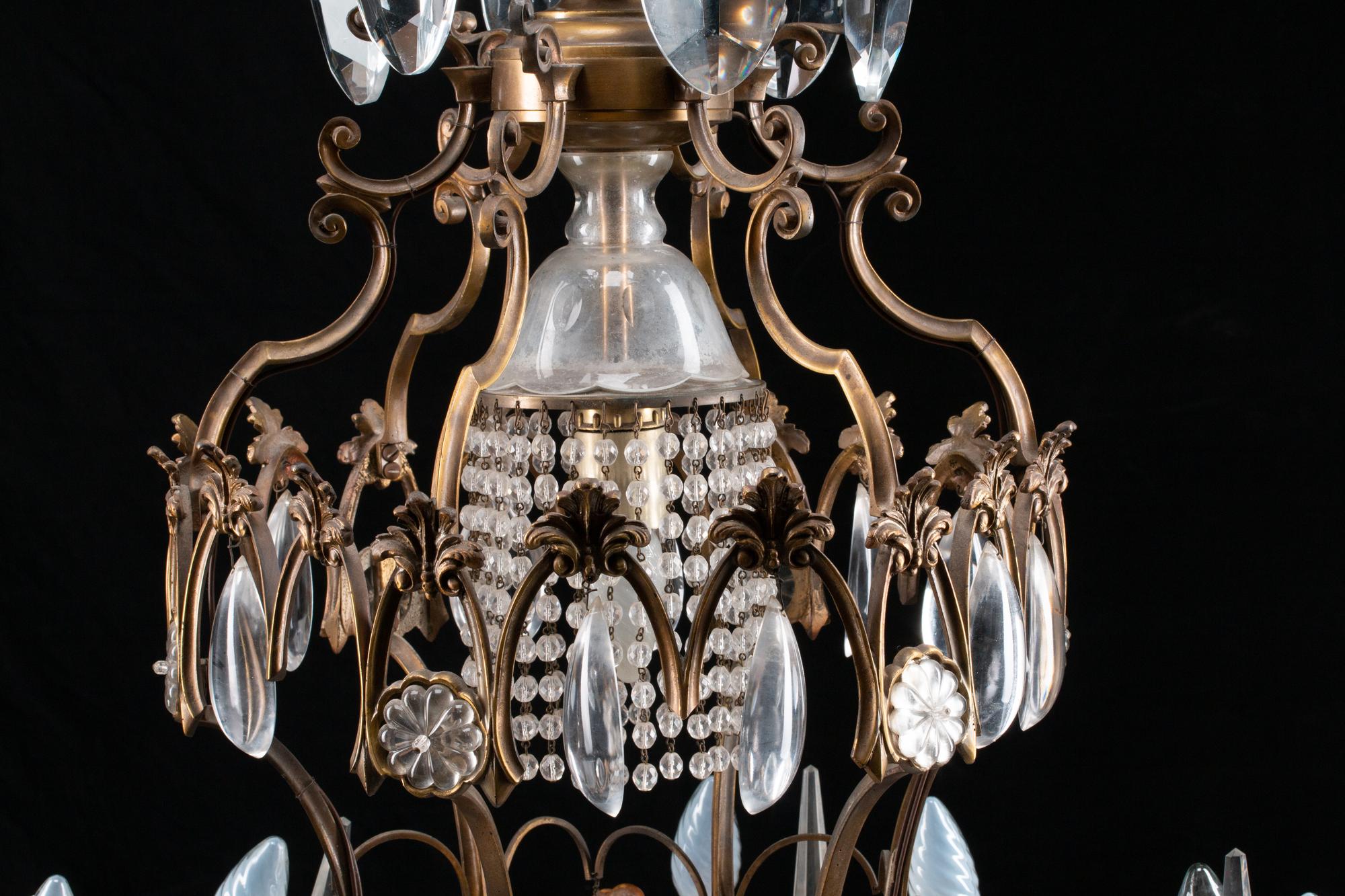 A Louis XV Style Patinated Bronze, Cut and Colored Glass Fourteen-Light Chandelier