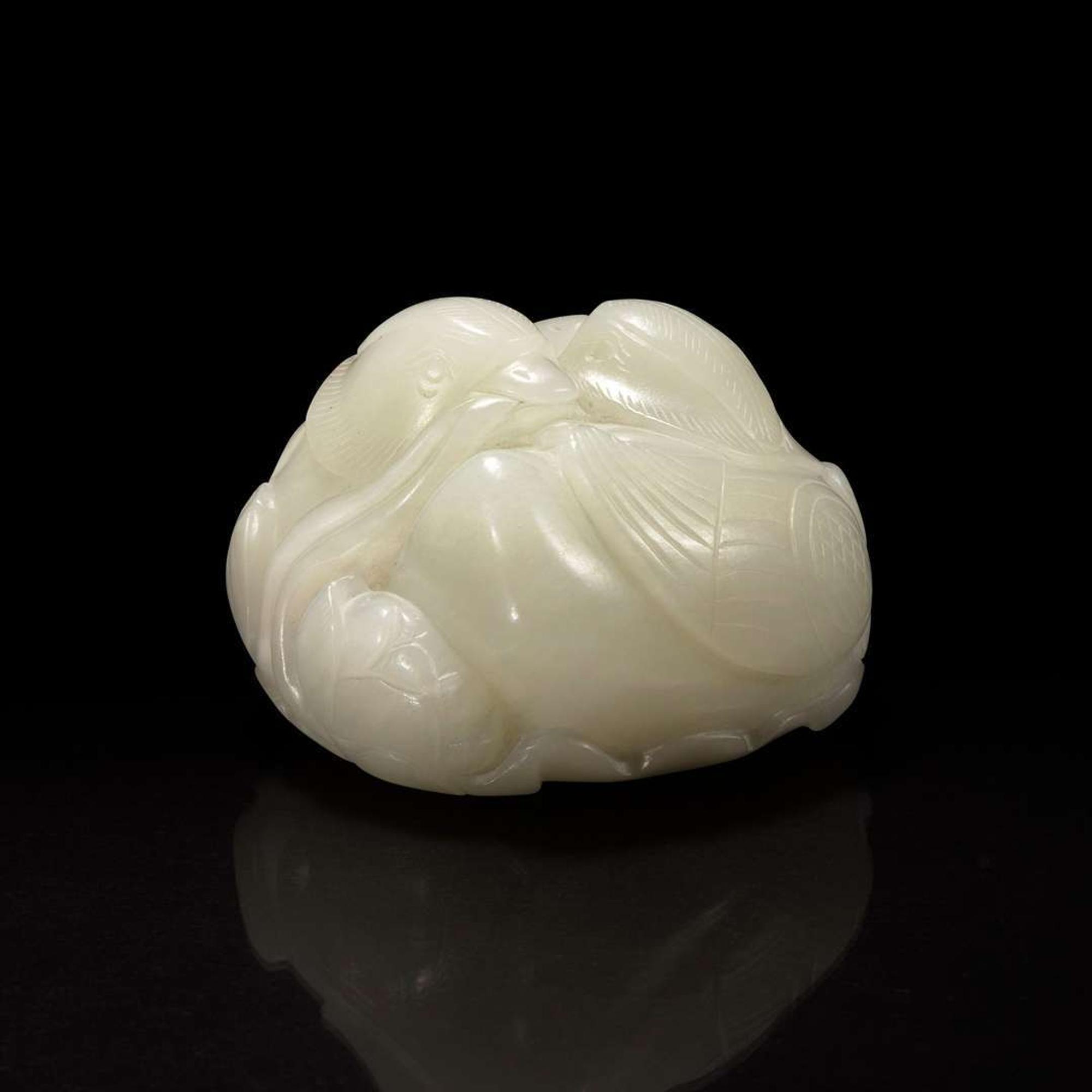 A Chinese white jade figural group depicting mandarin ducks 白玉雕双凫衔荷花 Qing Dynasty ?