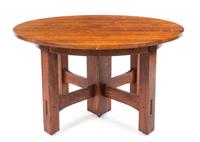 Gustav Stickley, (American, 1858-1942), an oak extension table, model no. 634, having a circular top expanding to oval, raised on squar