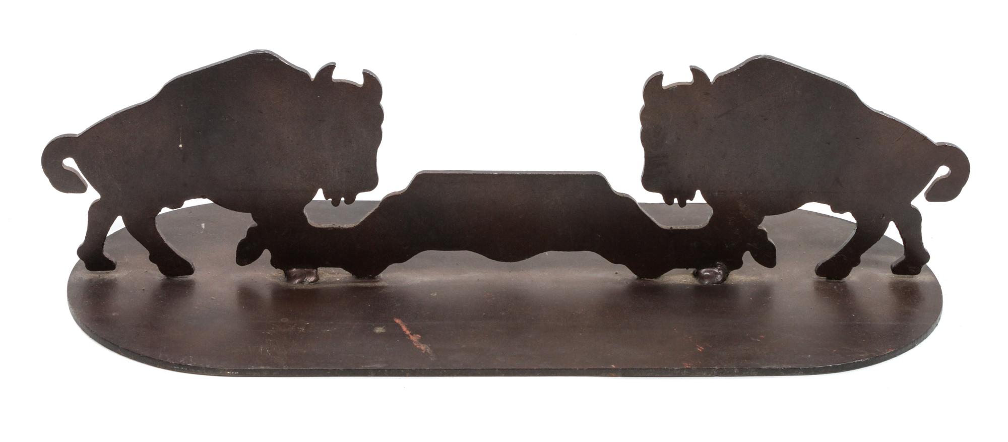 A Pair of Iron Door Stops Depicting Bison in Profile Each height 5 3/4 x width 21 x depth 8 inches.