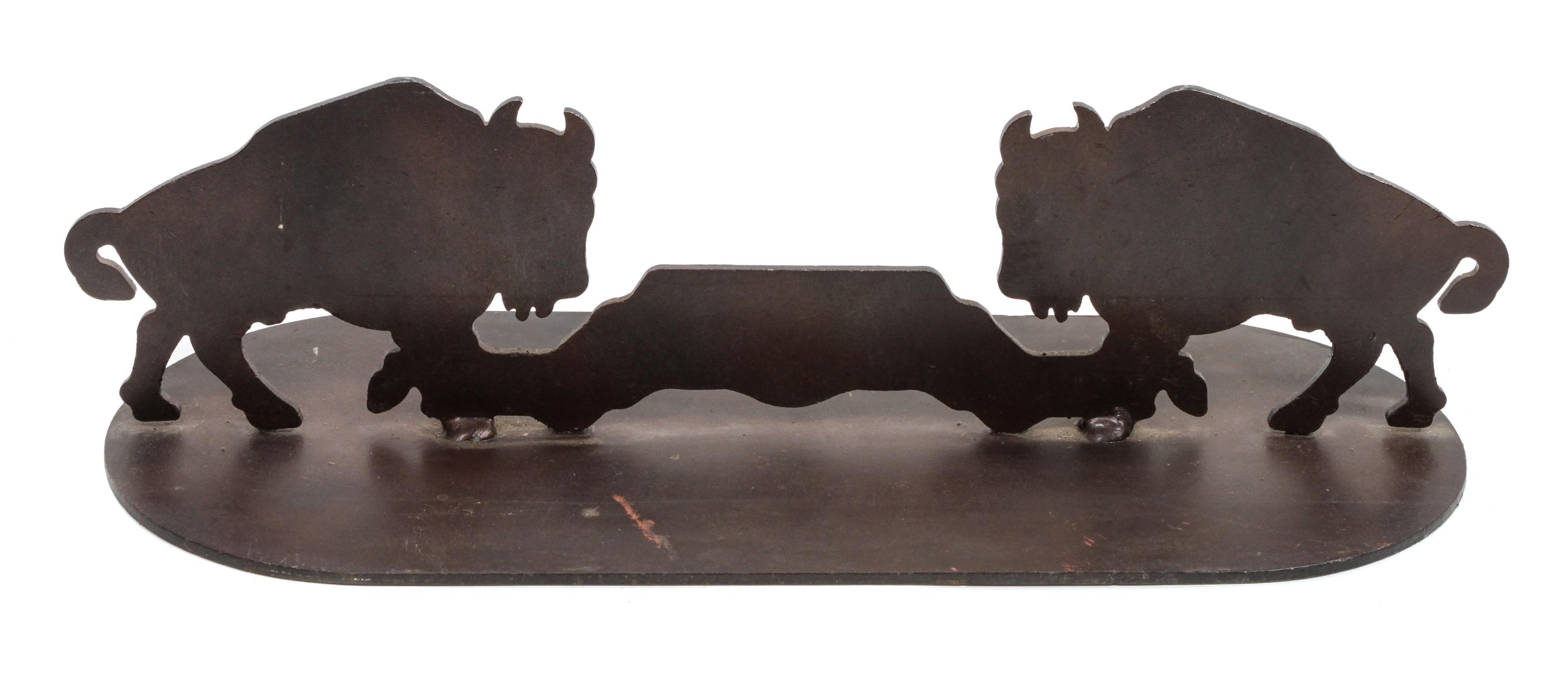A Pair of Iron Door Stops Depicting Bison in Profile Each height 5 3/4 x width 21 x depth 8 inches.