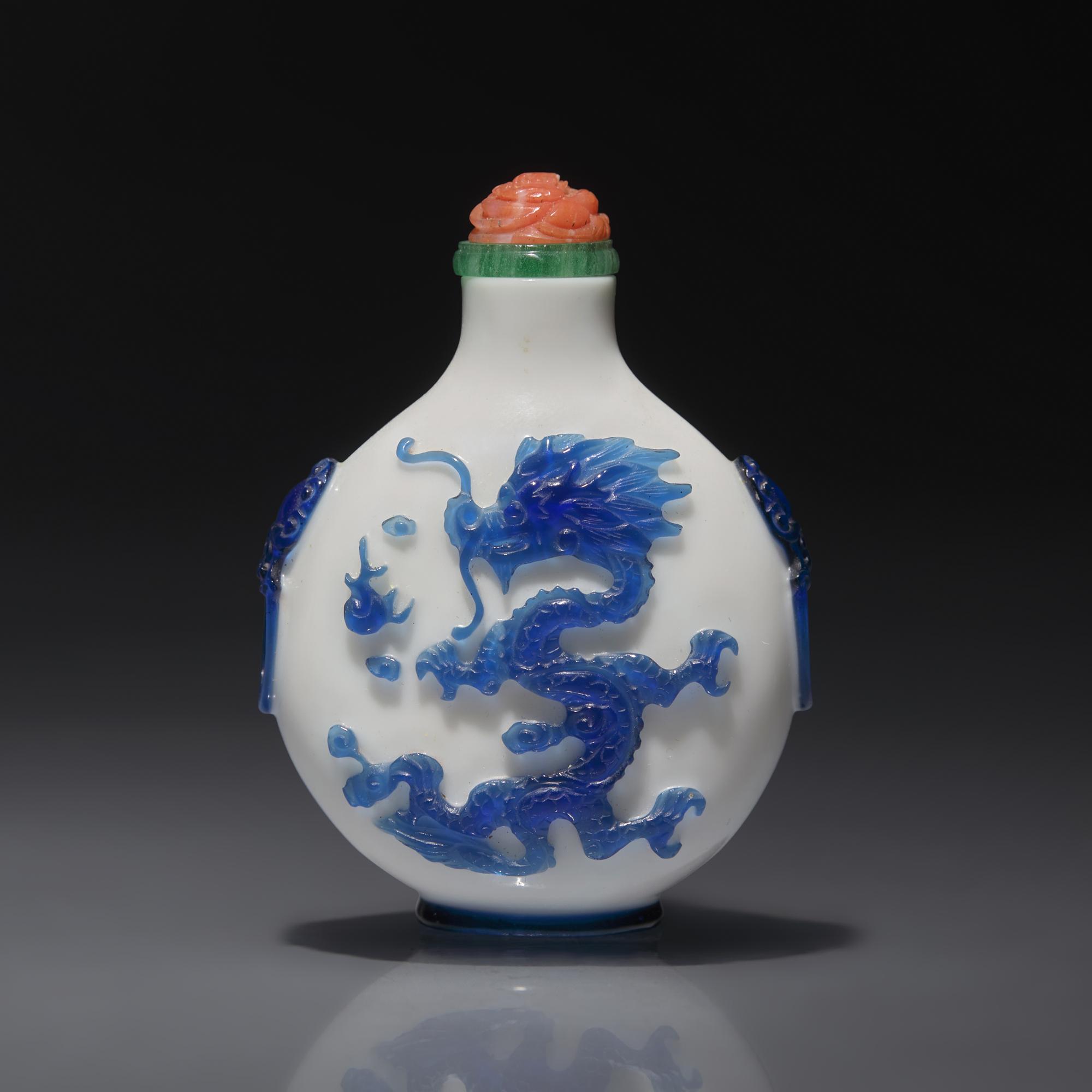 A Chinese Glass Overlay "Dragons" Snuff Bottle, Qing Dynasty, 18th/First Half 19th century — 清中期 涅白地套藍料雙龍戲珠紋鋪首啣環耳鼻煙壺