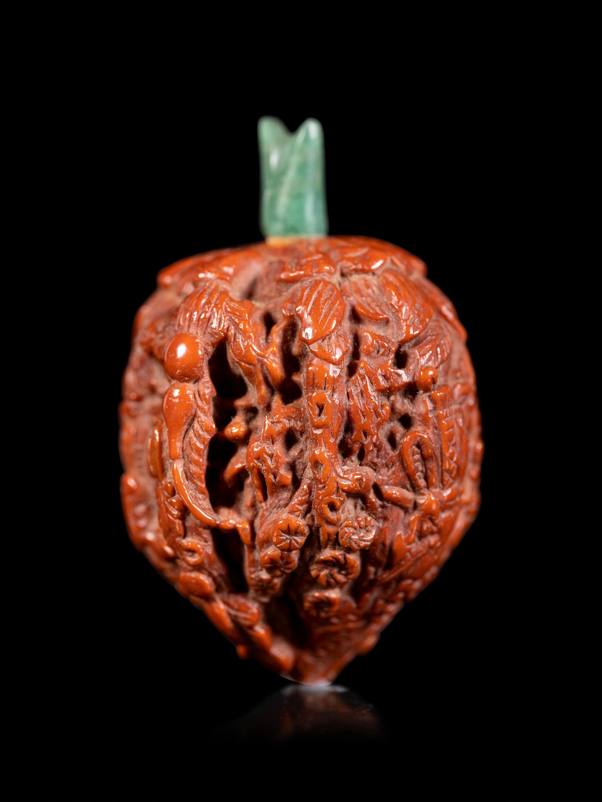 A Chinese Carved Peach Pit Snuff Bottle