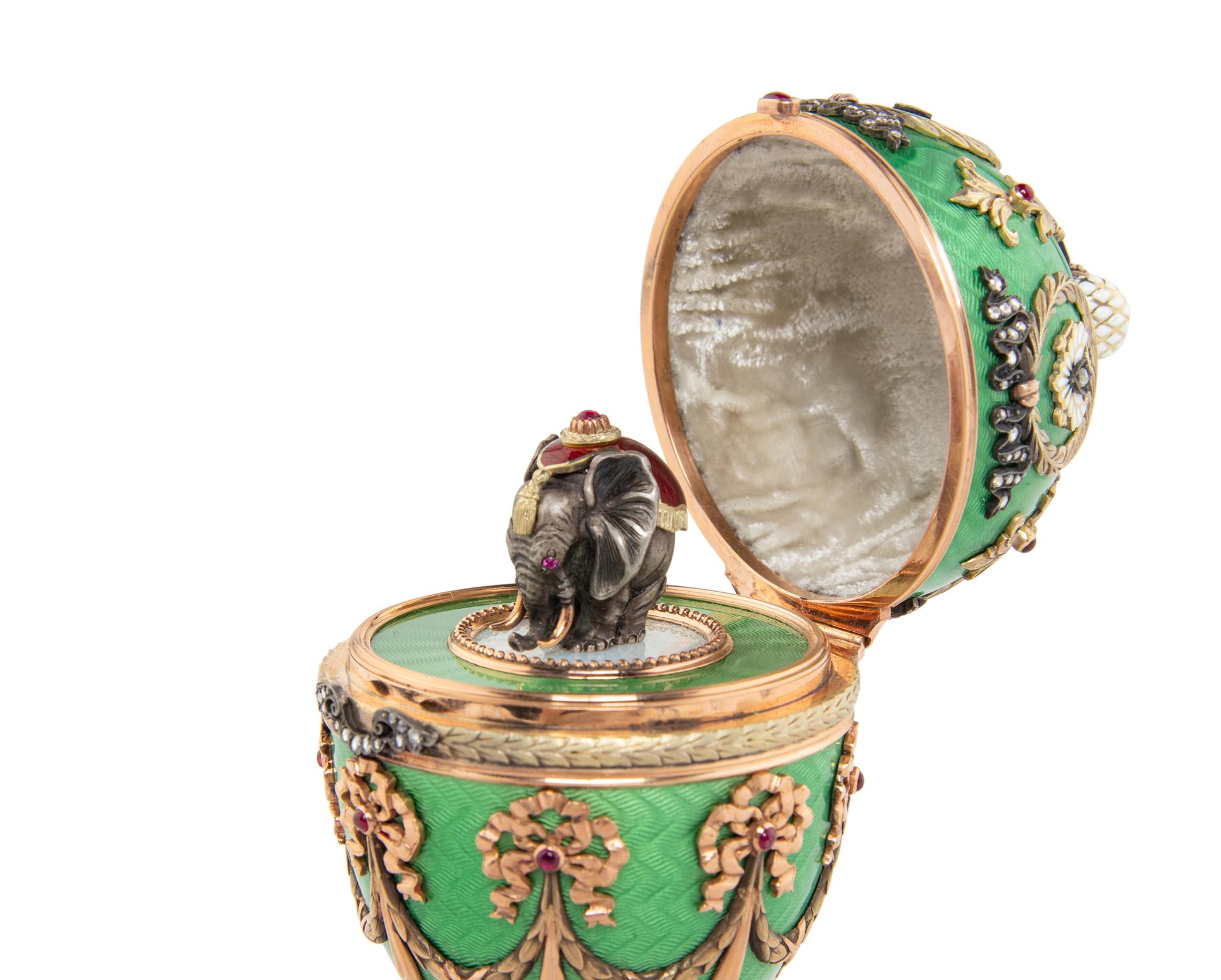 A Gold, Guilloché Enamel and Gemstone-Mounted Surprise Egg