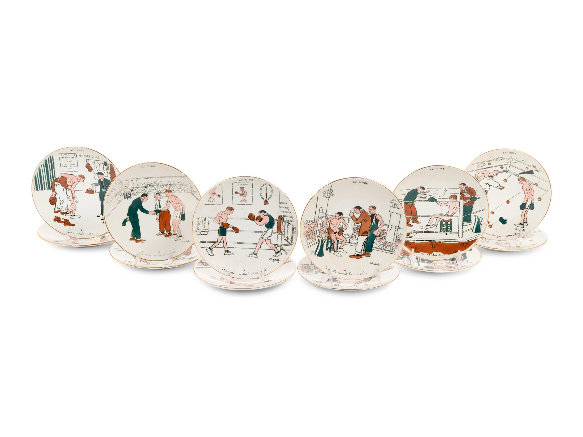 A Set of Twelve Le Boxe Decorative Plates Featuring Boxing Scenes by C. R. Genty,