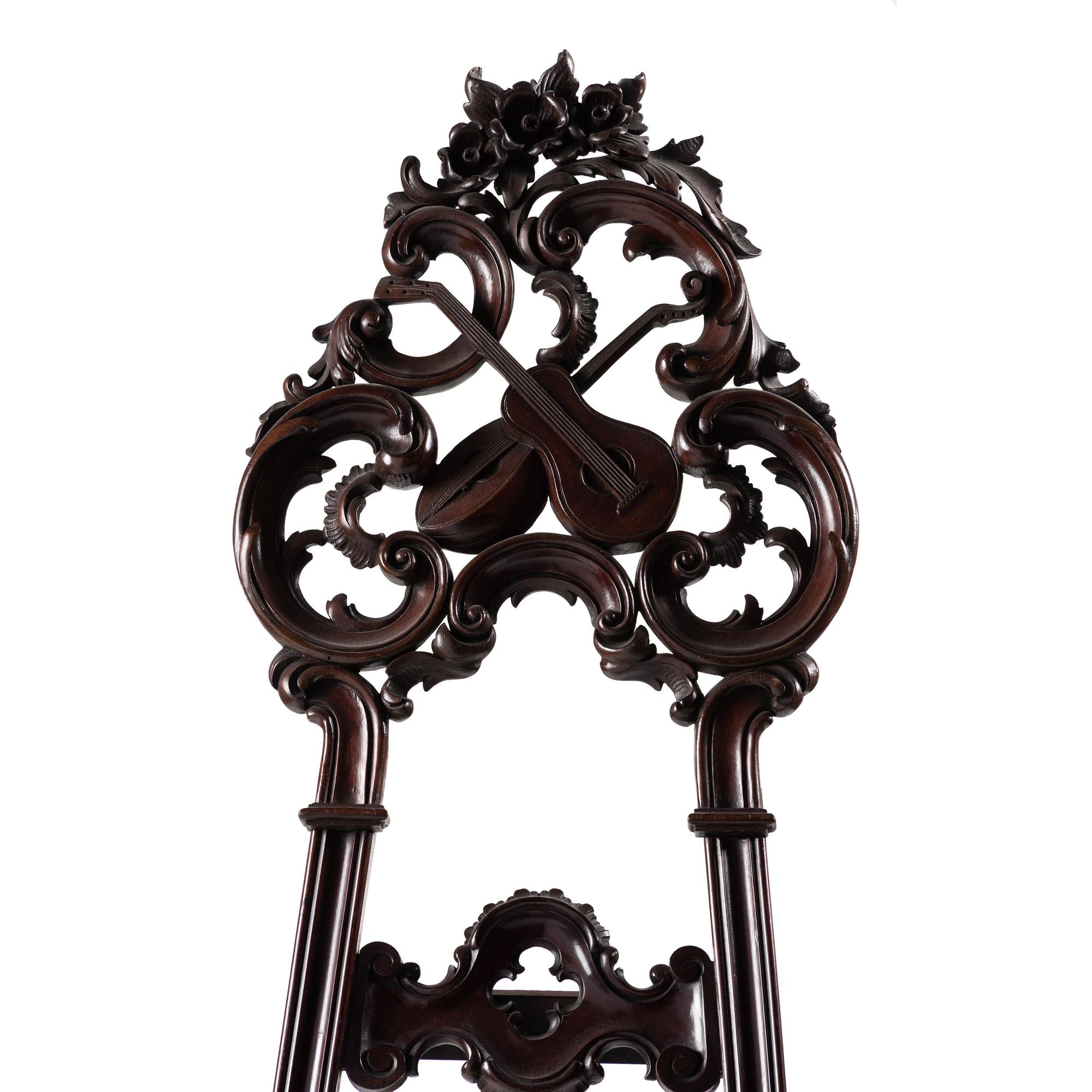 A Renaissance Revival Carved Walnut Musical Easel