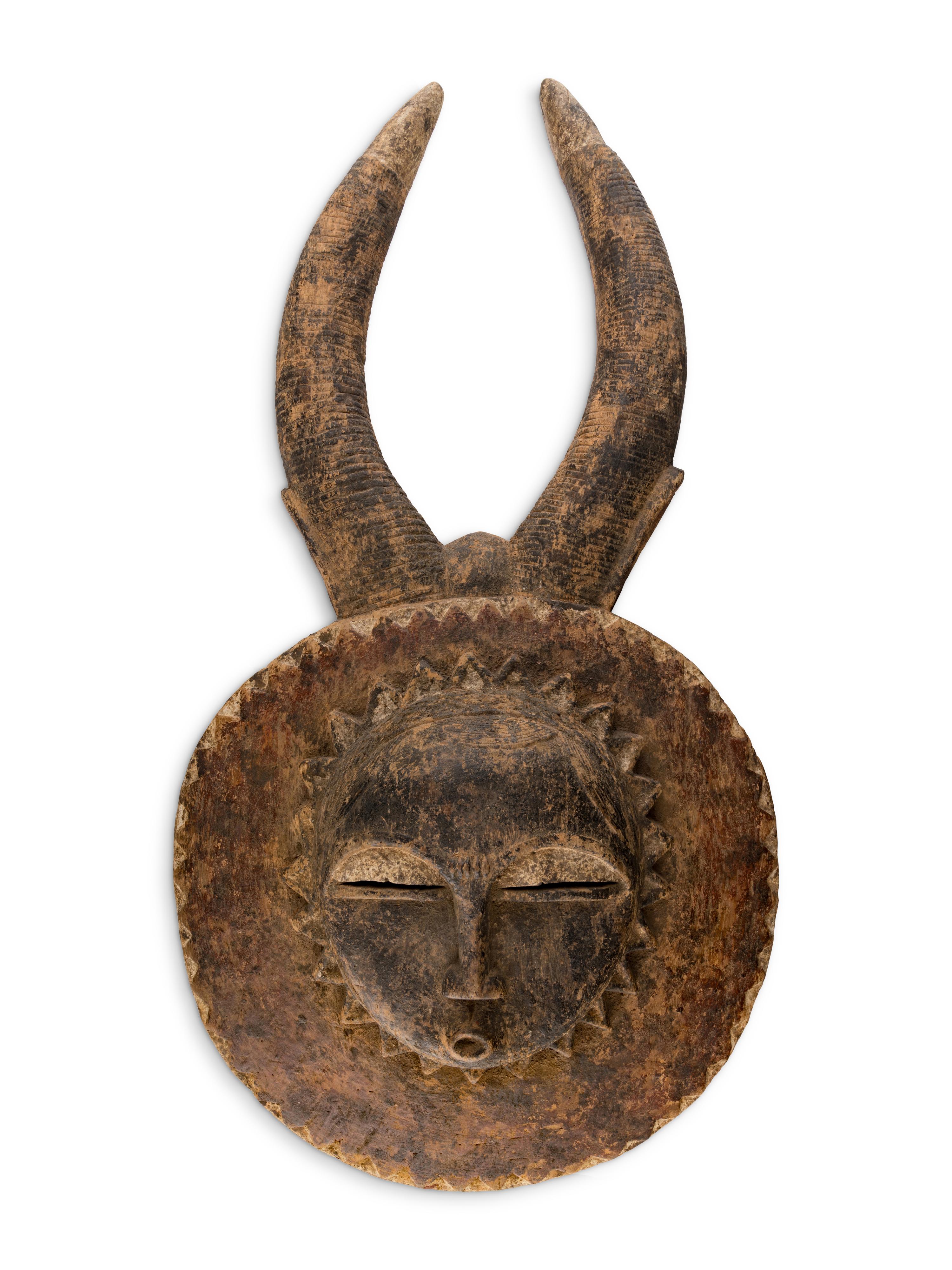 An African Carved Wood Horned Sun Mask
