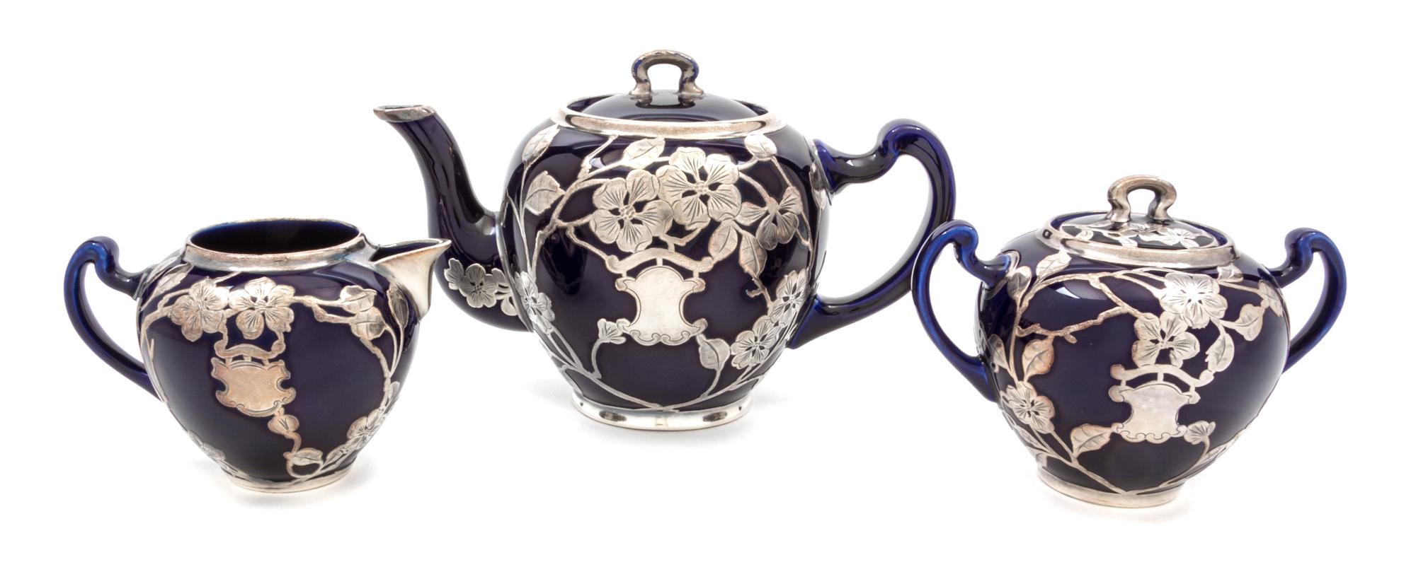 A Lenox Porcelain Silver Overlay Partial Tea Service Height of teapot 5 5/8 inches.
