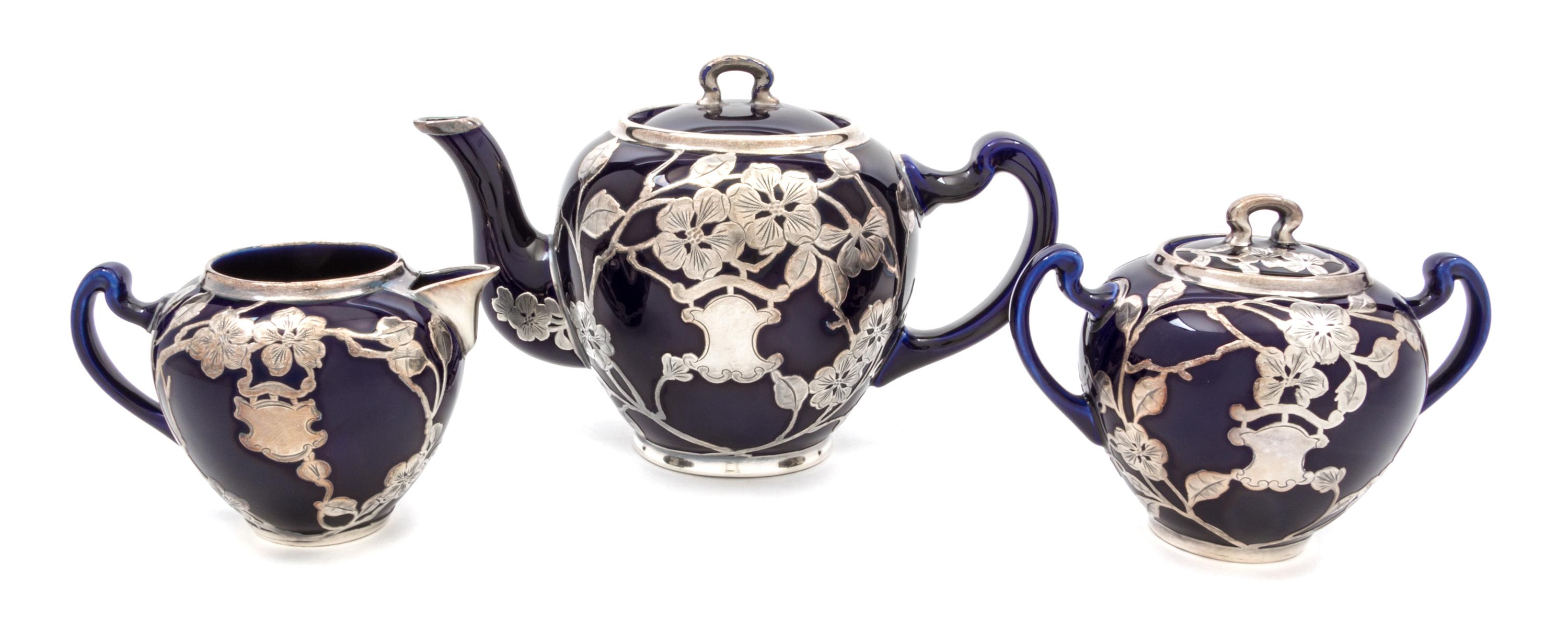 A Lenox Porcelain Silver Overlay Partial Tea Service Height of teapot 5 5/8 inches.