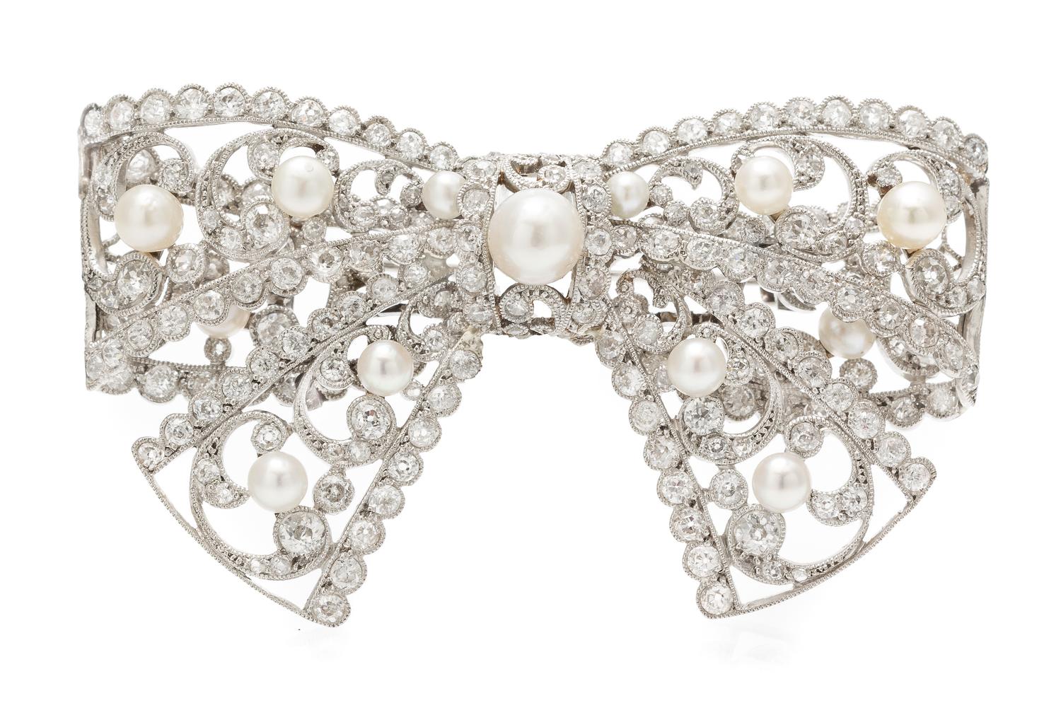 An Edwardian Platinum, Diamond and Pearl Bow Brooch, 23.00 dwts.
