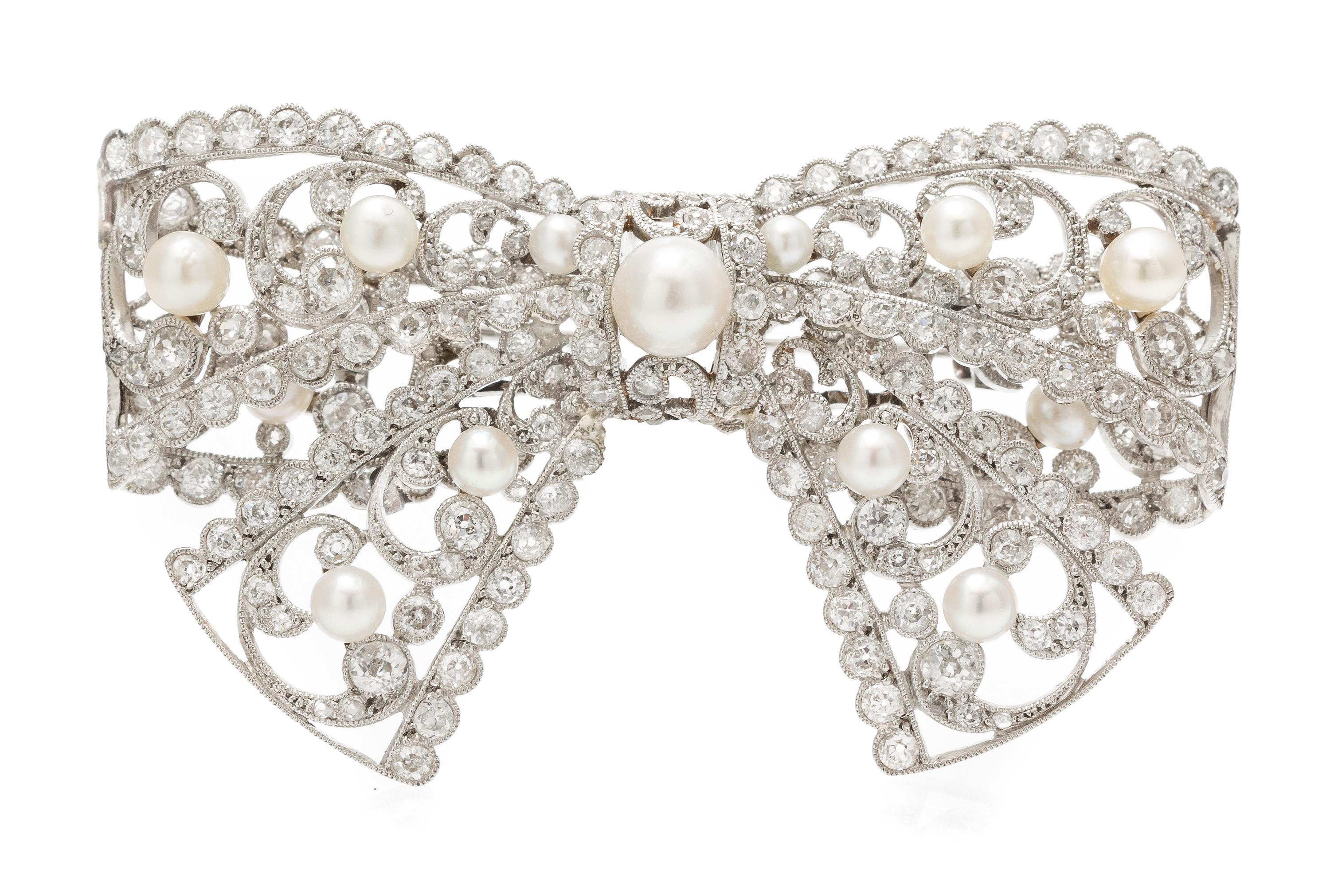 An Edwardian Platinum, Diamond and Pearl Bow Brooch, 23.00 dwts.