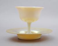 A Steuben Aurene Glass Sherbet and Underplate, Height overall 4 1/4 inches.