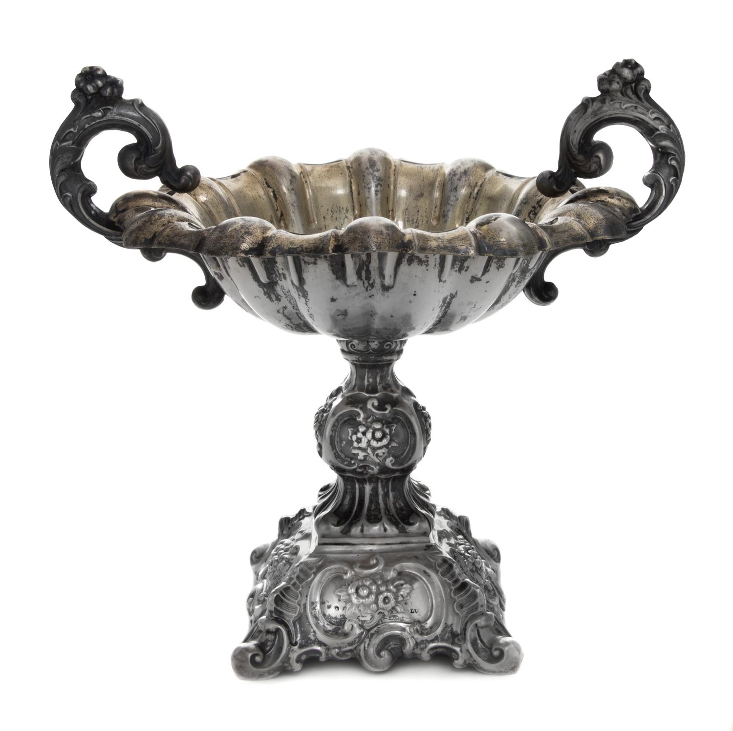 A Continental Silver Compote, , having foliate worked scroll handles, raised on a repousse worked base worked to show floral sprays wit