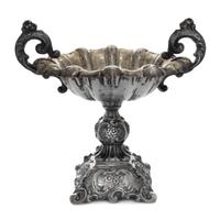 A Continental Silver Compote, , having foliate worked scroll handles, raised on a repousse worked base worked to show floral sprays wit