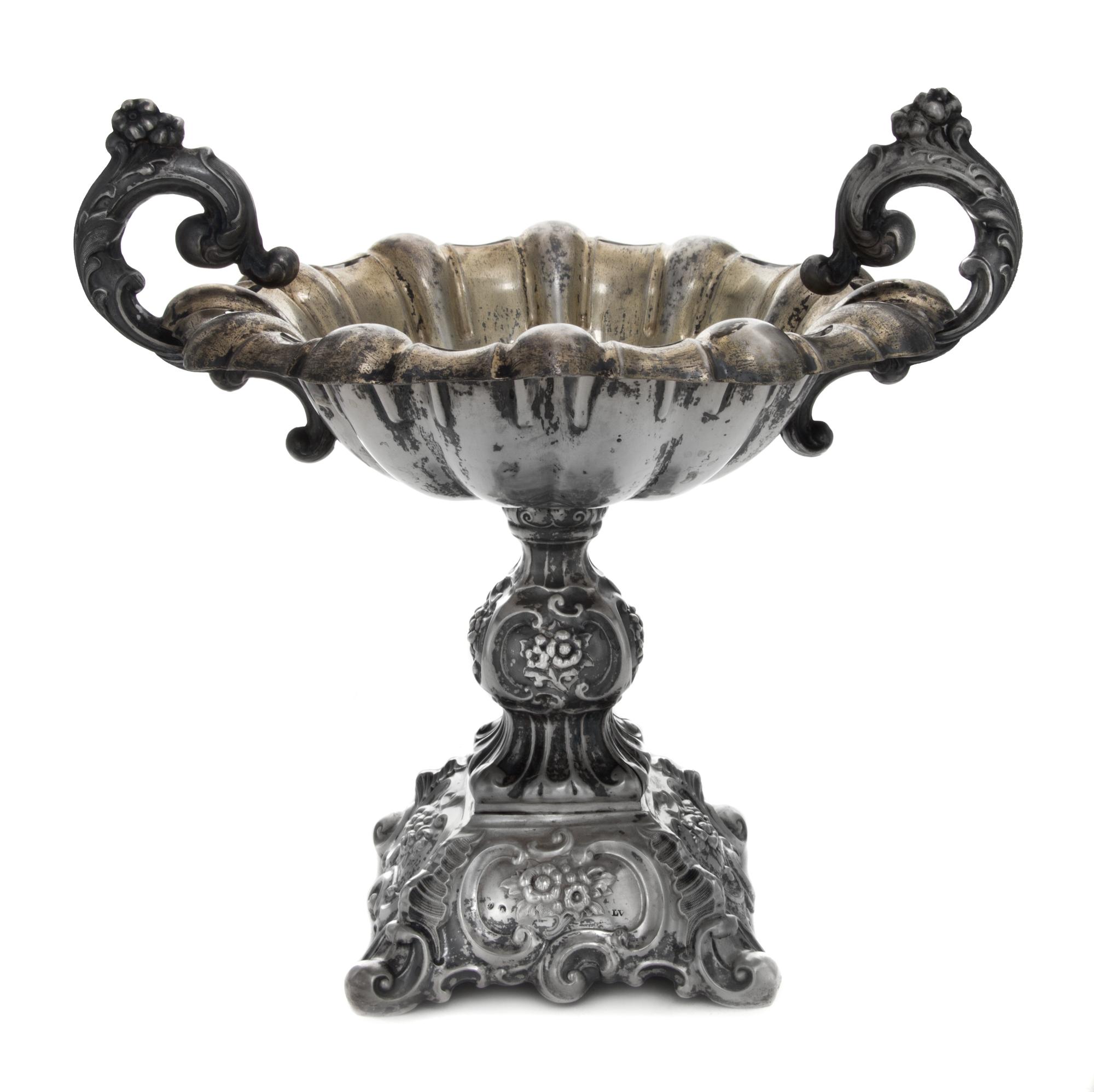 A Continental Silver Compote, , having foliate worked scroll handles, raised on a repousse worked base worked to show floral sprays wit