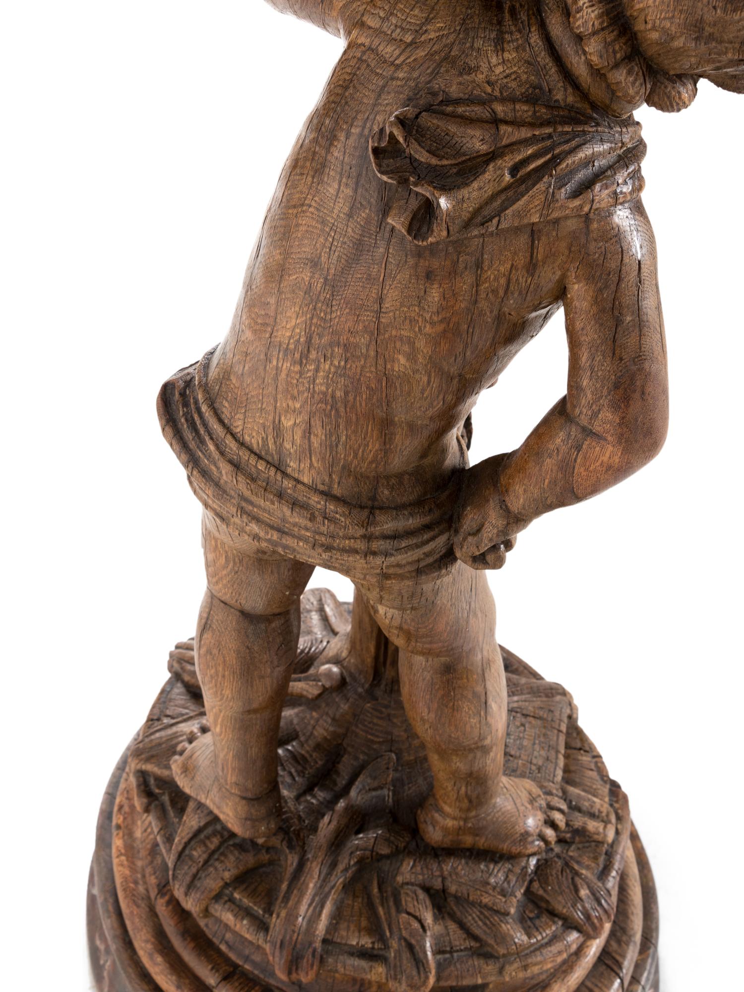 A Continental Carved Oak Figural Pedestal