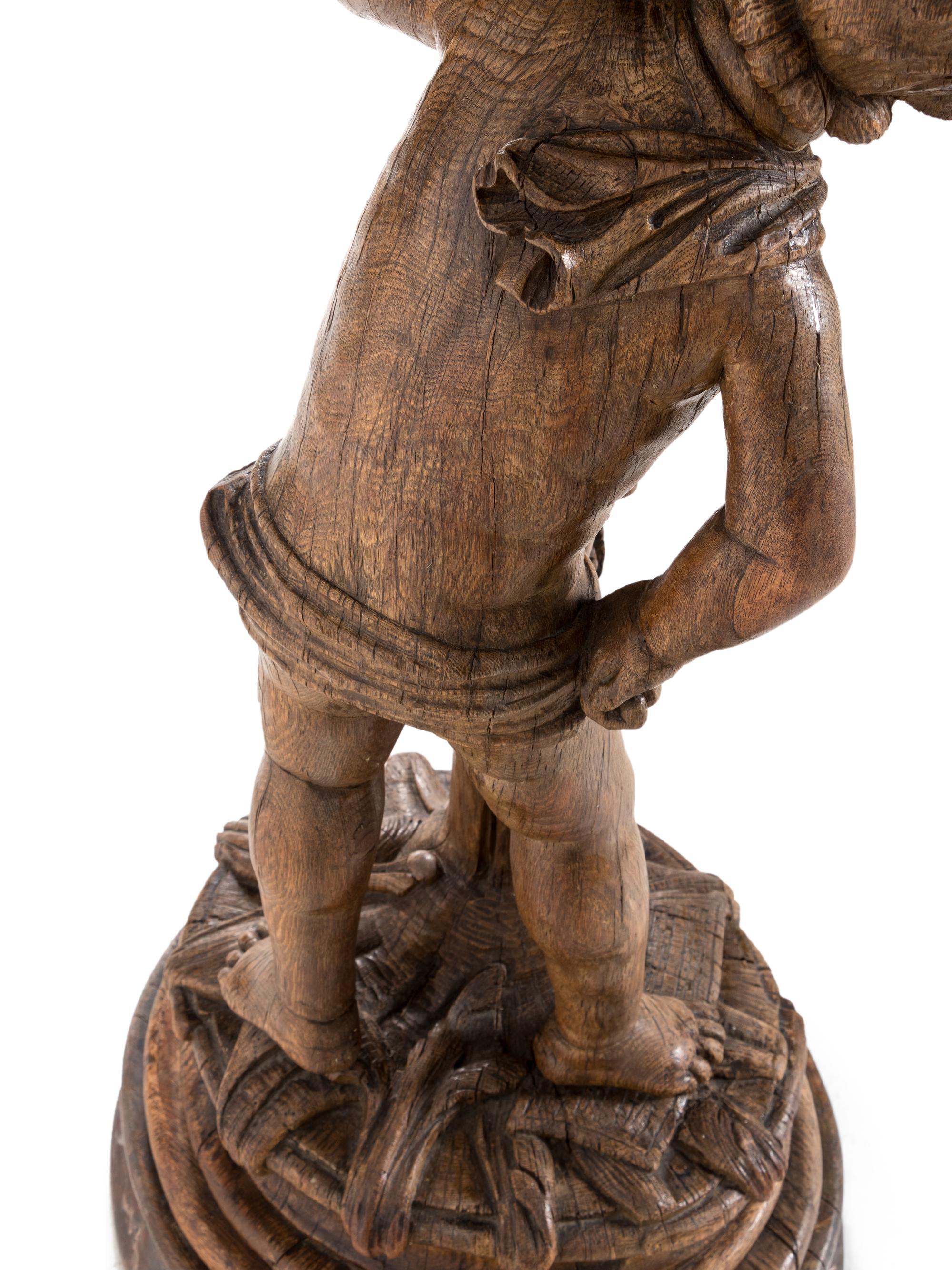 A Continental Carved Oak Figural Pedestal