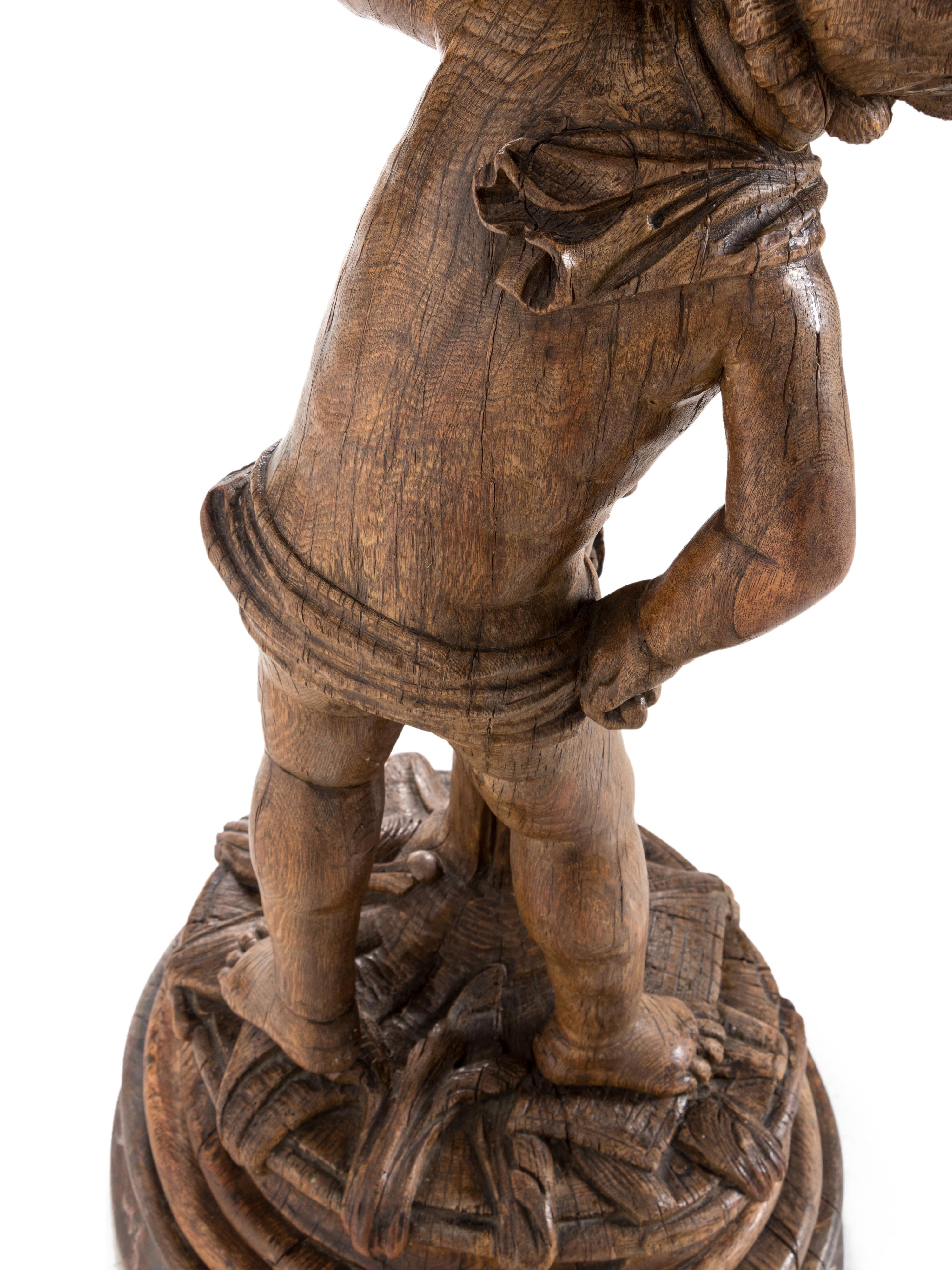 A Continental Carved Oak Figural Pedestal