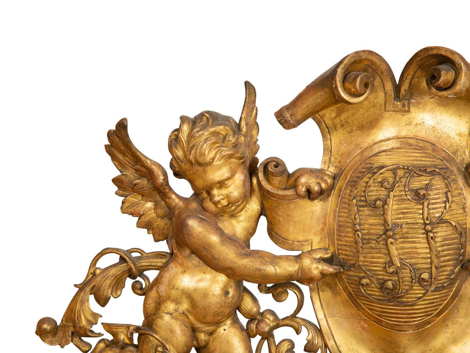 A Continental Carved Giltwood Cherub Wall Plaque