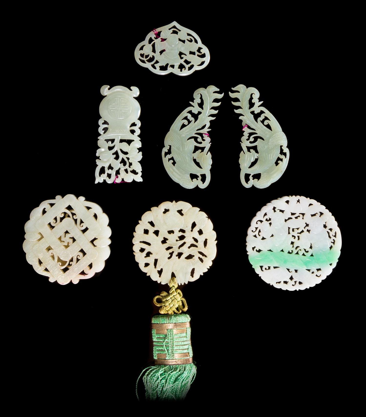 Seven Reticulated Jade, Jadeite and Serpentine Pendants Diameter of largest 2 1/4 inches. — 19TH CENTURY