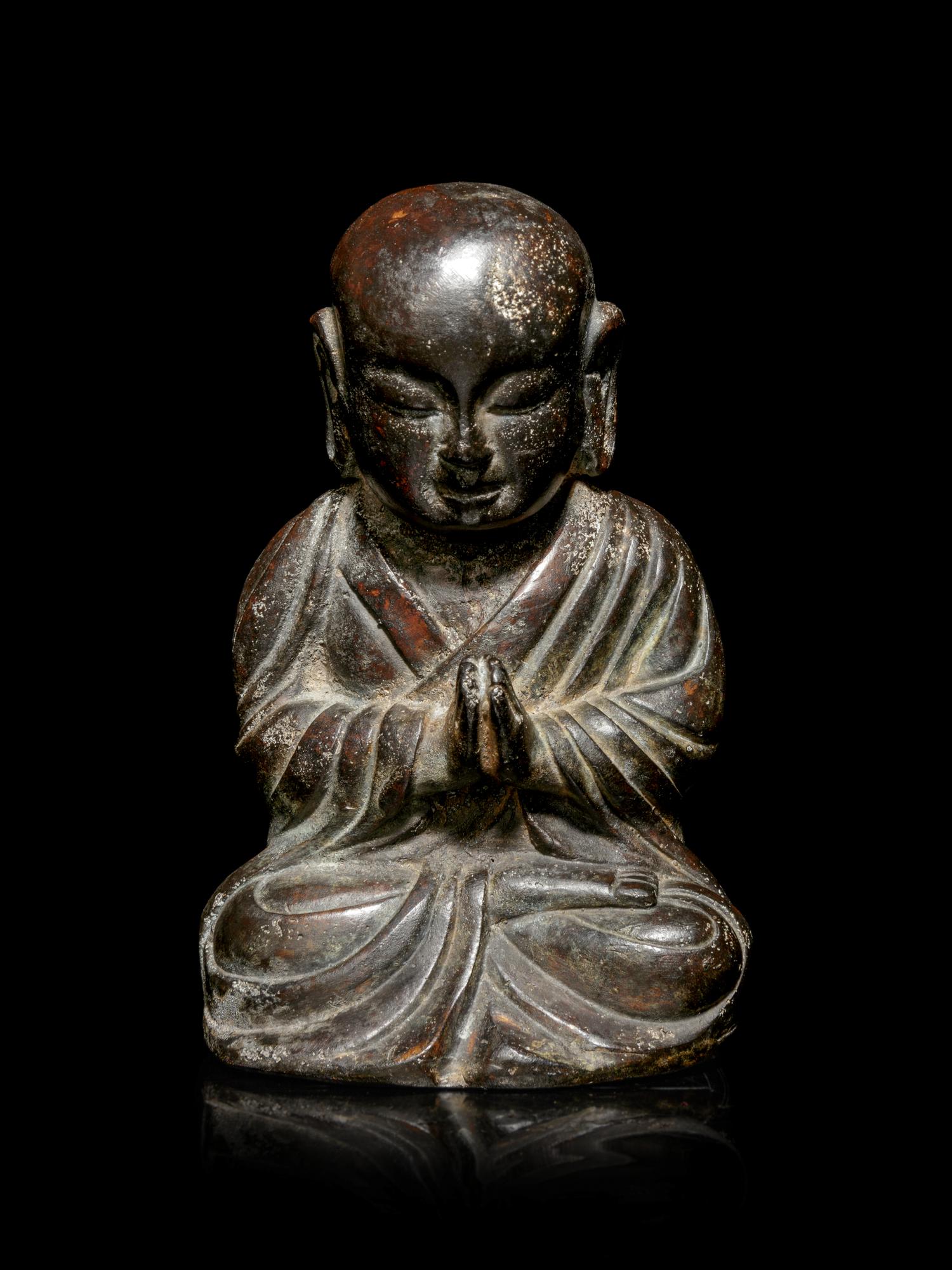 A Small Bronze Figure of a Seated Monk