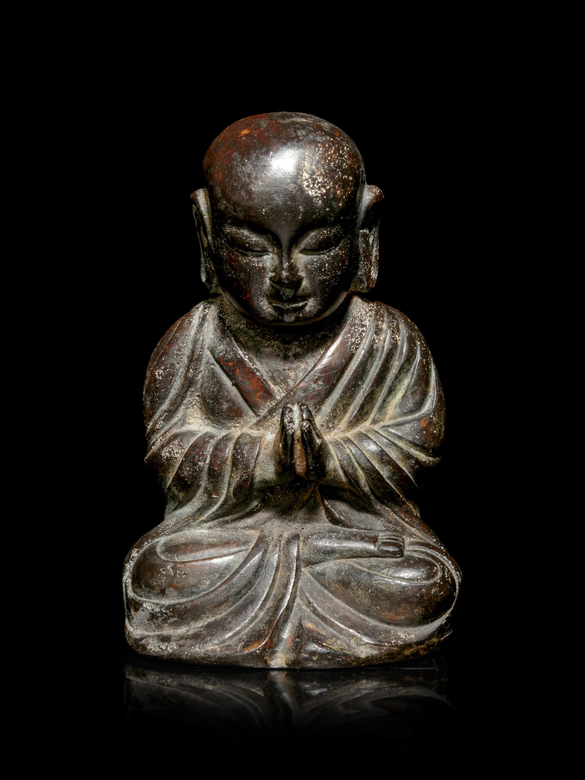 A Small Bronze Figure of a Seated Monk