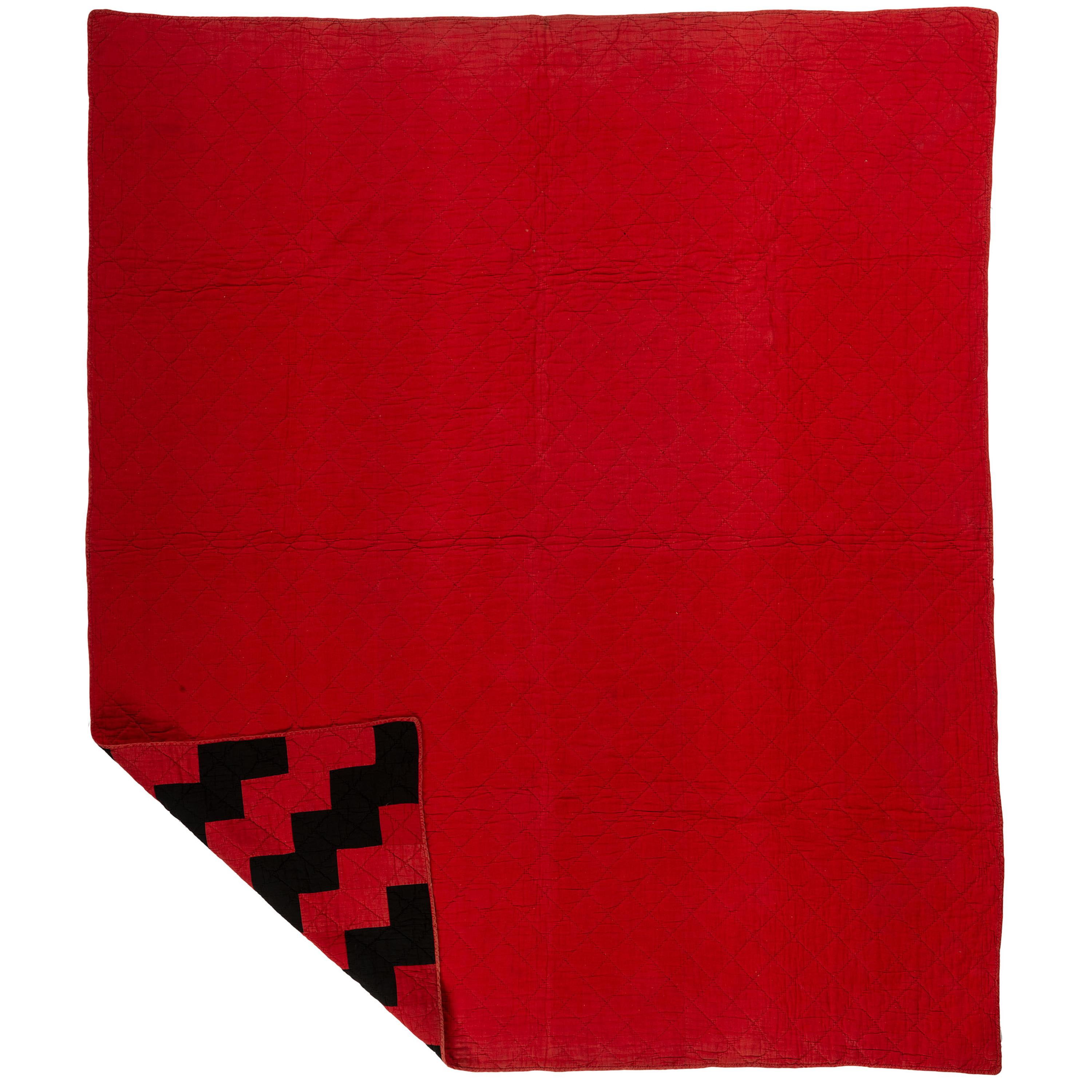 A Red and Black Pieced Zig Zag Pattern Quilt