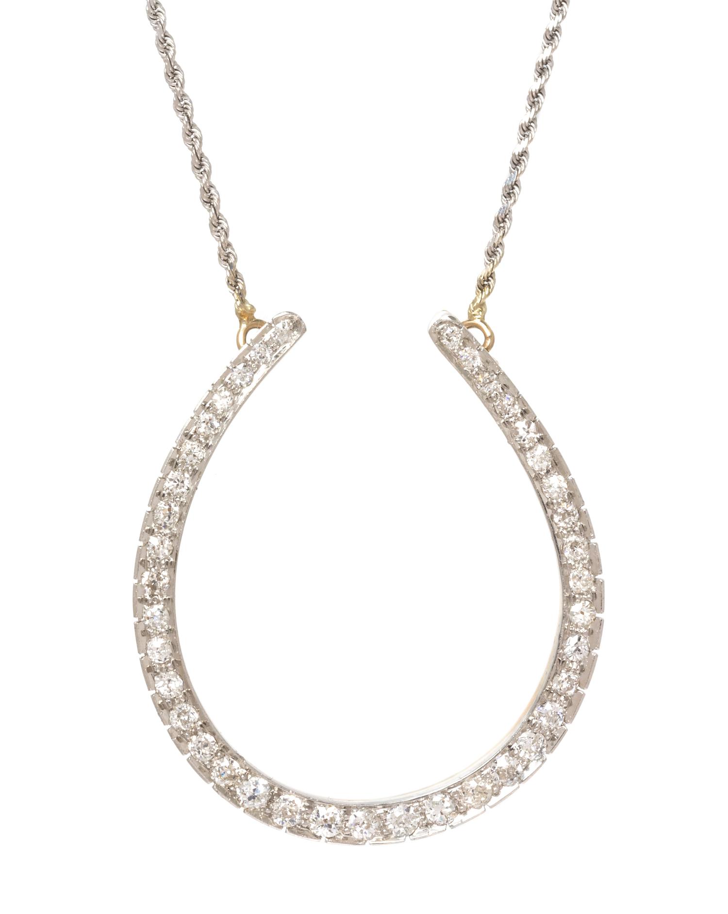 An Edwardian Platinum Topped Rose Gold and Diamond Horseshoe Necklace, 11.10 dwts.
