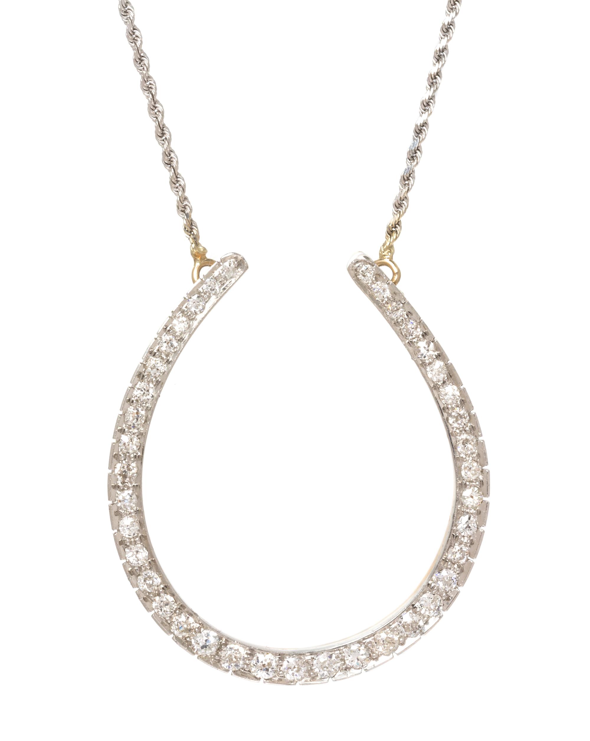 An Edwardian Platinum Topped Rose Gold and Diamond Horseshoe Necklace, 11.10 dwts.
