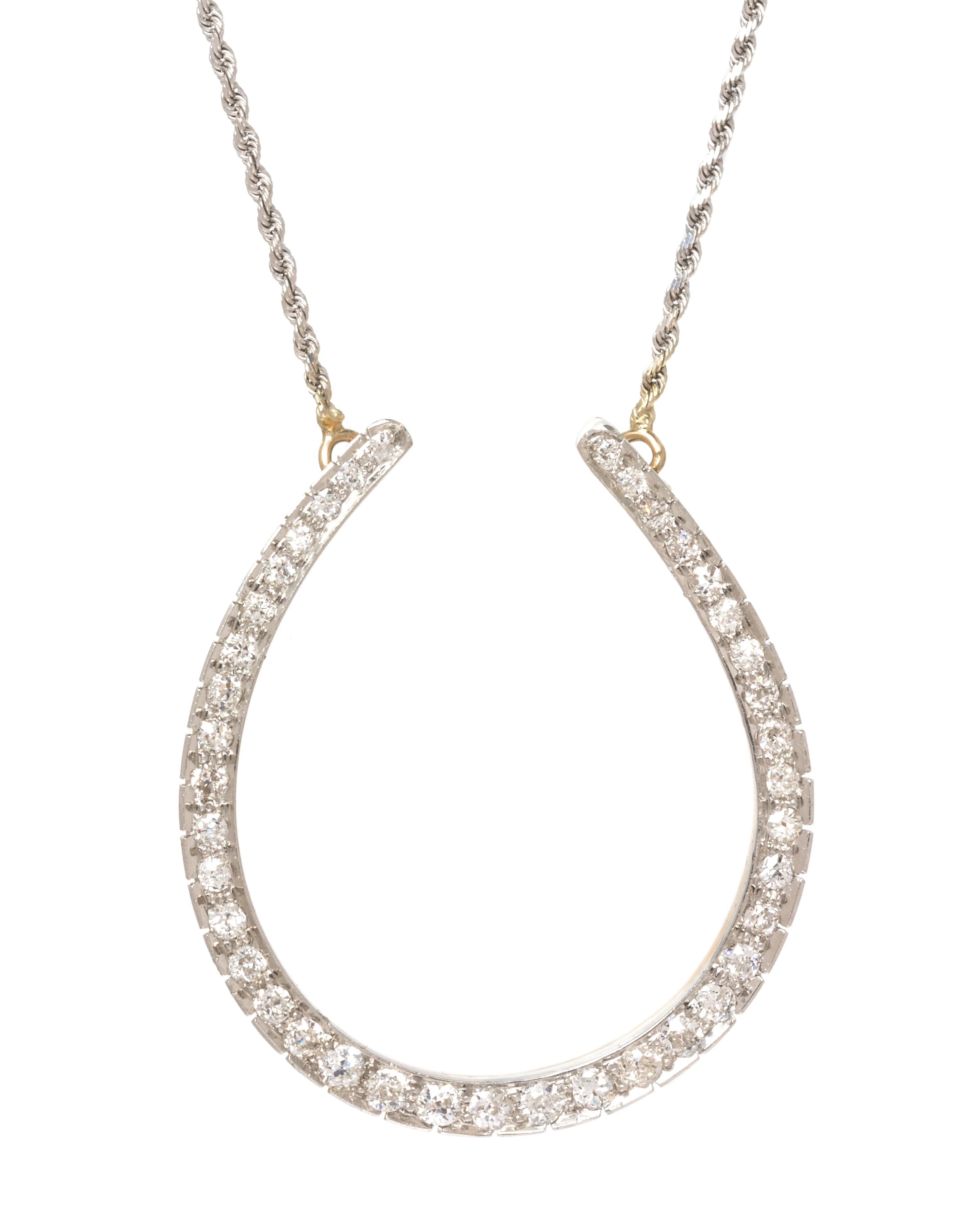 An Edwardian Platinum Topped Rose Gold and Diamond Horseshoe Necklace, 11.10 dwts.