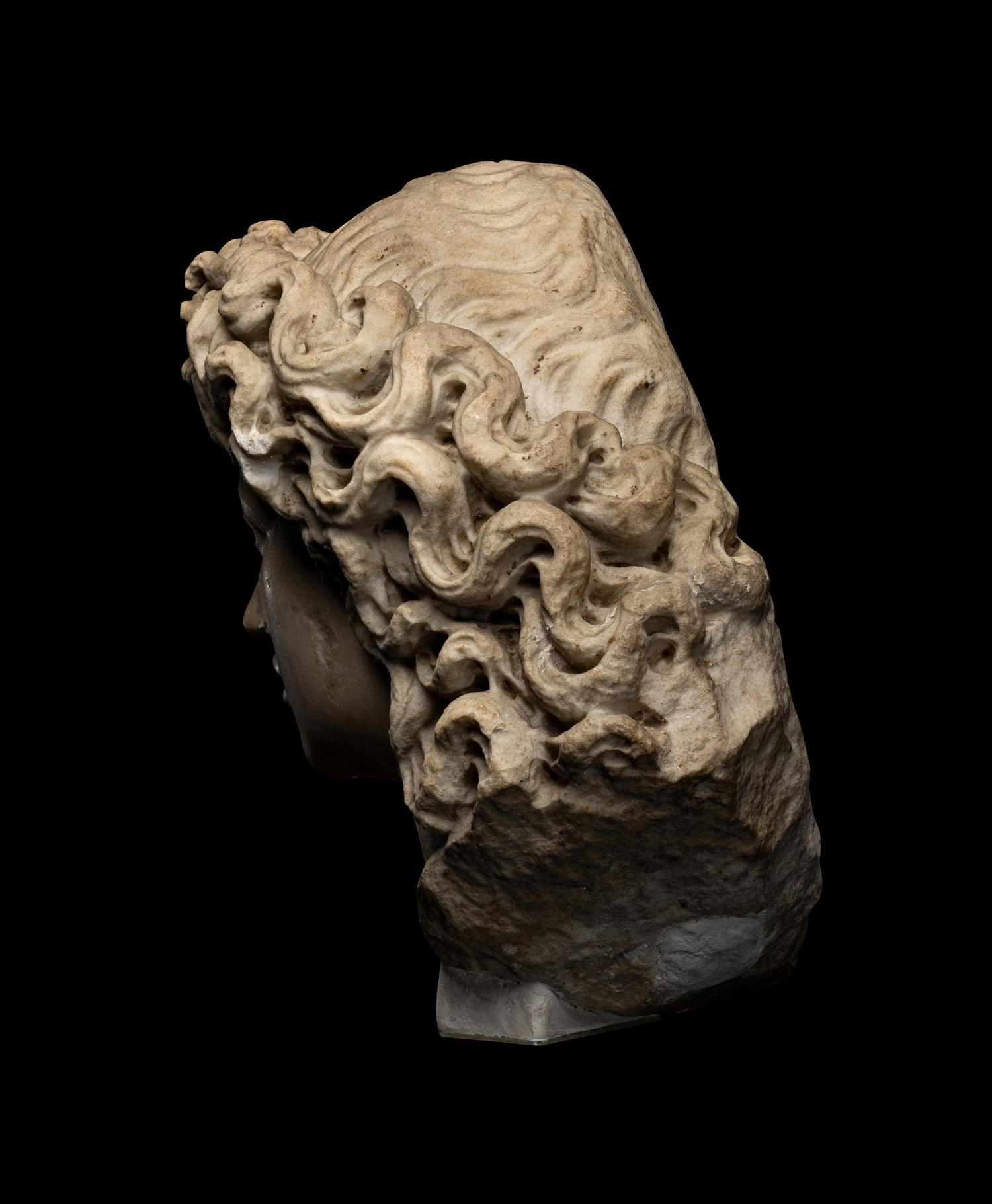 A Roman Marble Head of a Triton