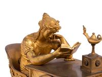An Empire Gilt Bronze and Marble Figural Mantel Clock