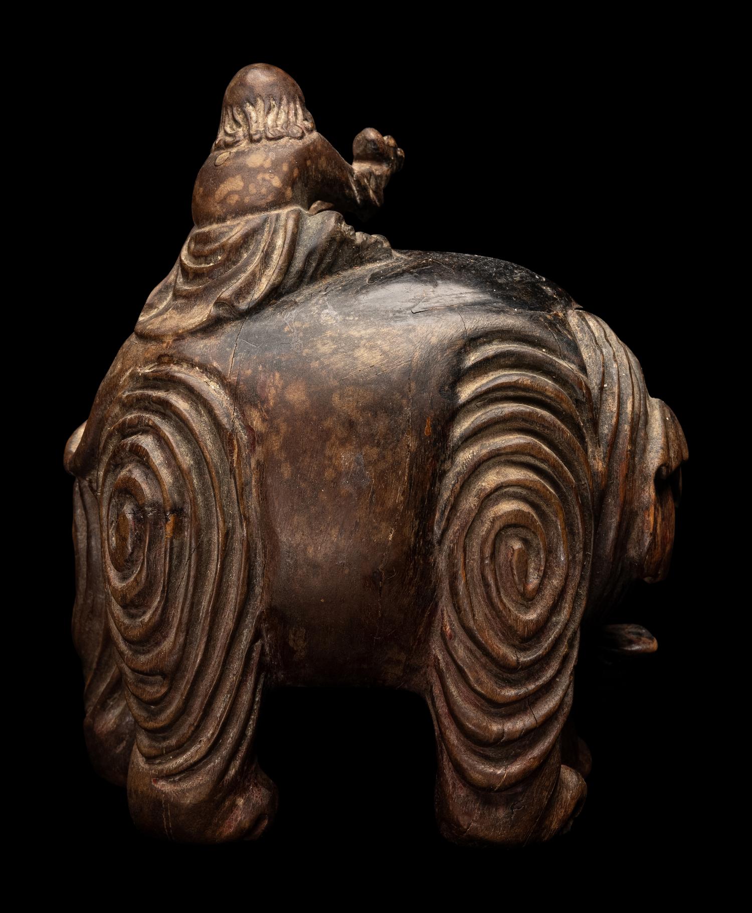 A Chinese Carved Wood 'Foreigner and Elephant' Figural Group