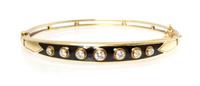 A 14 Karat Yellow Gold, Diamond and Enamel Bangle Bracelet, 10.80 dwts.