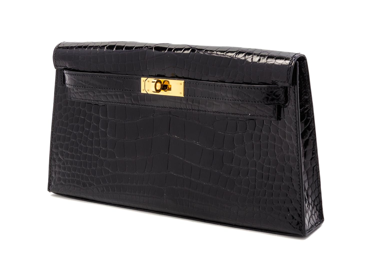 An Hermes Black Shiny Alligator Kelly Clutch Bag, 11 x 6 x 1 1/2 inches.