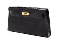 An Hermes Black Shiny Alligator Kelly Clutch Bag, 11 x 6 x 1 1/2 inches.