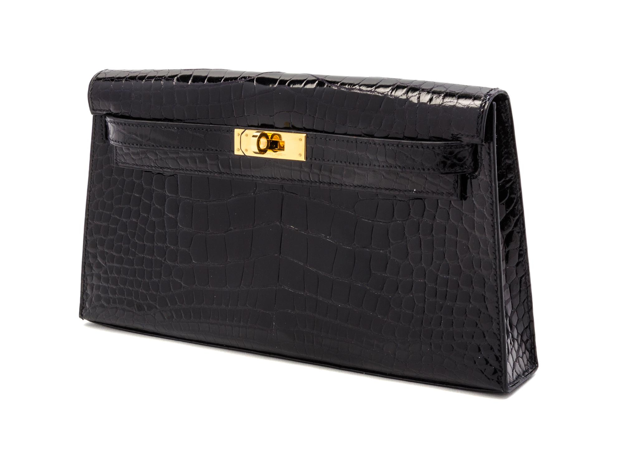 An Hermes Black Shiny Alligator Kelly Clutch Bag, 11 x 6 x 1 1/2 inches.
