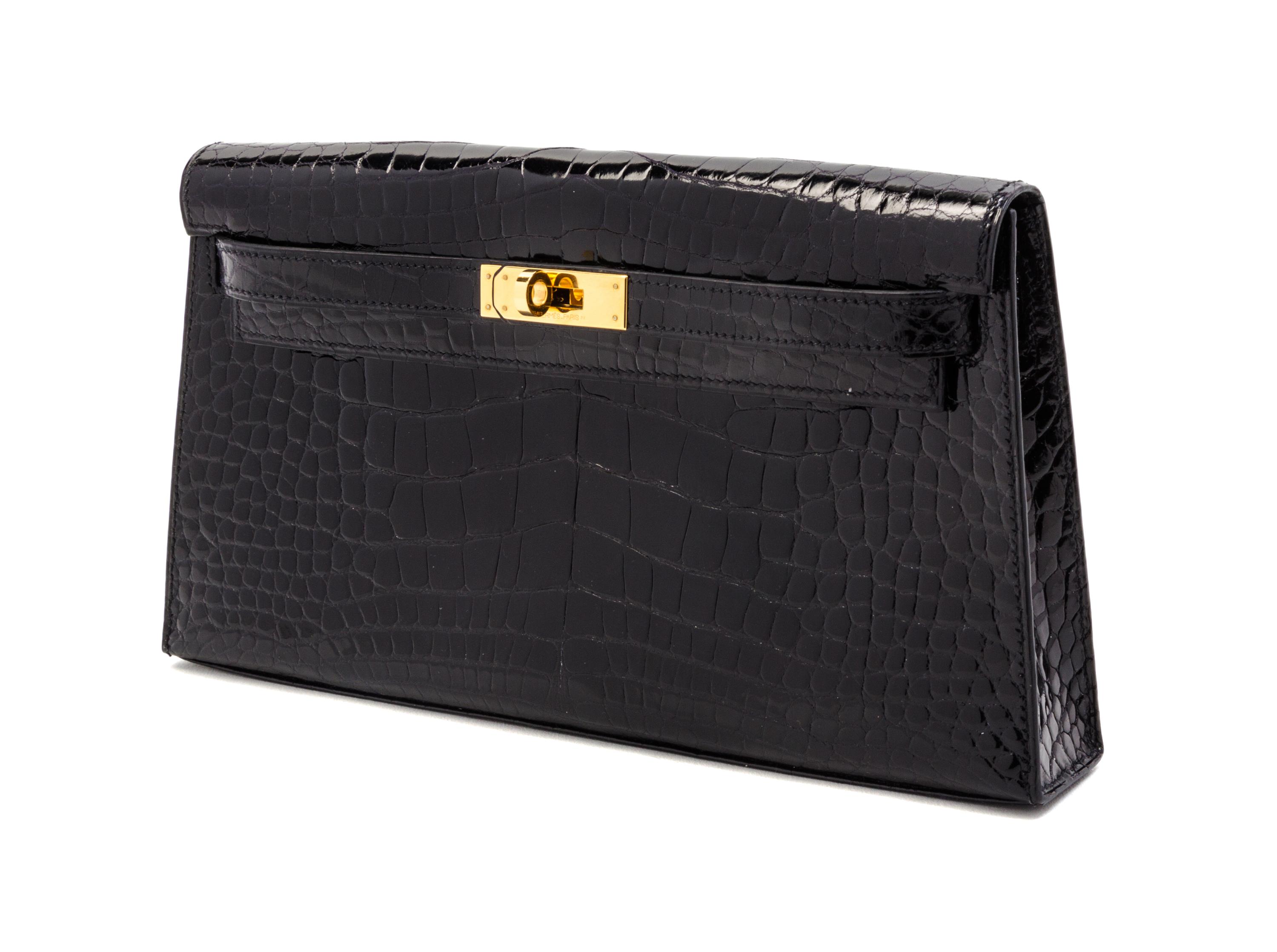 An Hermes Black Shiny Alligator Kelly Clutch Bag, 11 x 6 x 1 1/2 inches.