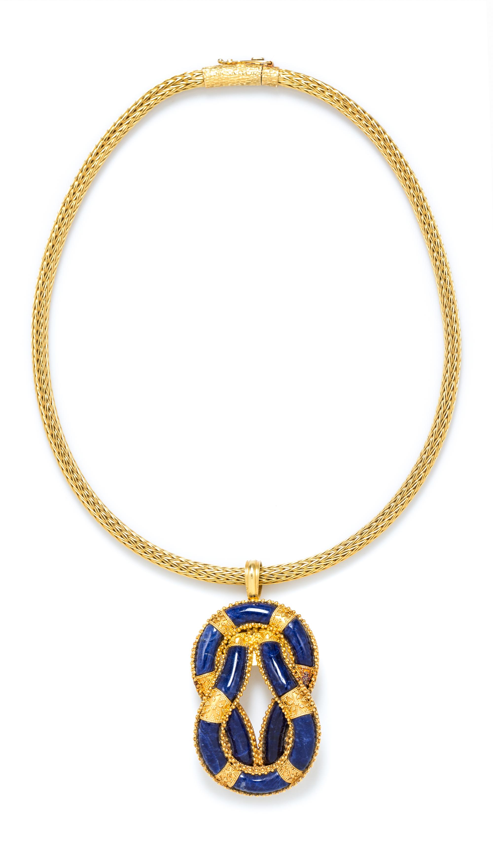An 18 Karat Yellow Gold and Sodalite 'Hercules Knot' Pendant and Chain, Ilias Lalaounis, Circa 1970's, 41.30 dwts.