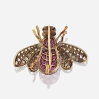 A silver topped gold, ruby, diamond, and sapphire brooch