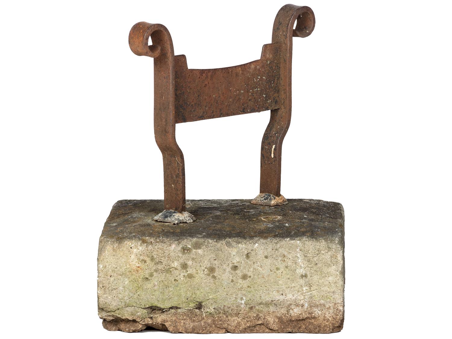 A Wrought Iron Boot Scrape with Stone Base