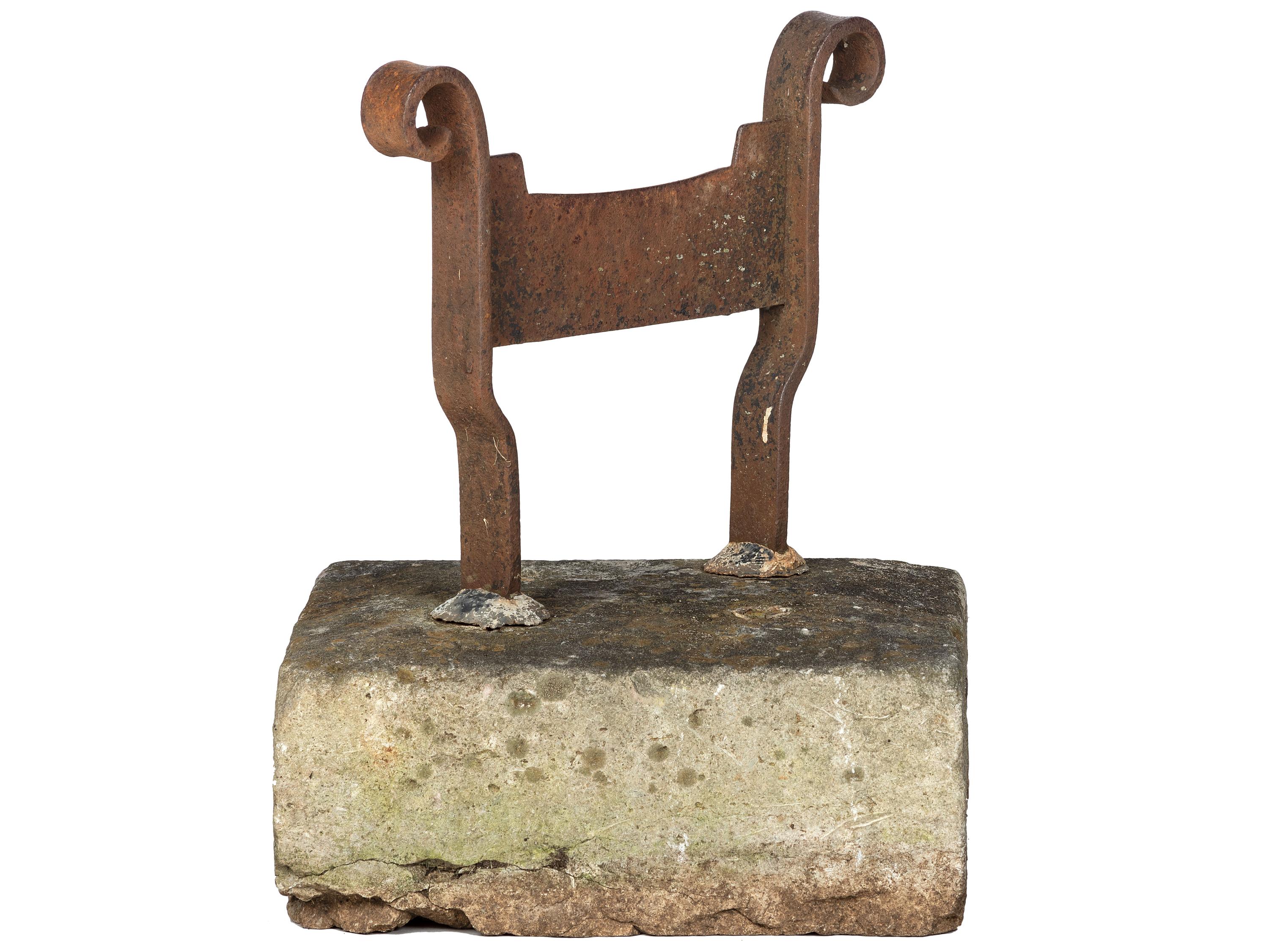 A Wrought Iron Boot Scrape with Stone Base