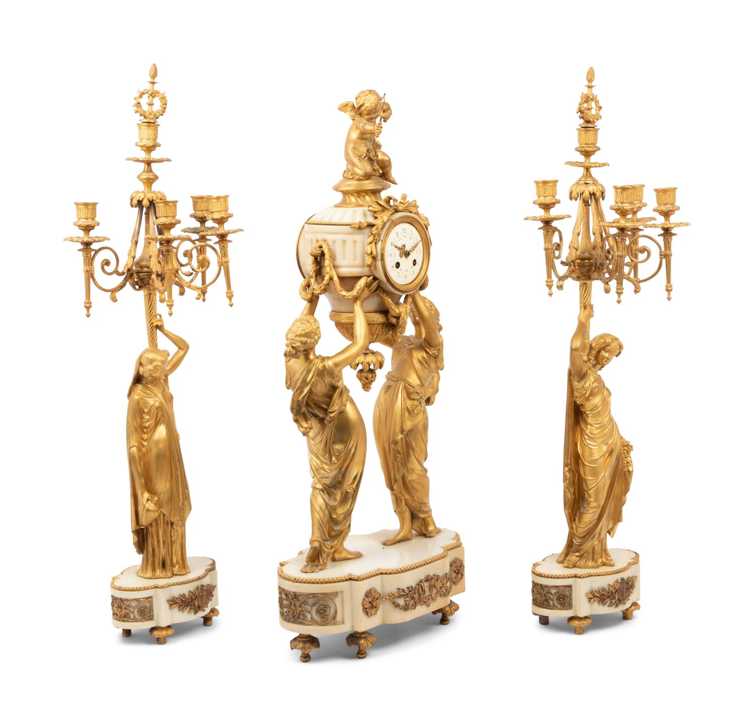A Louis XVI Style Gilt Bronze and Marble Figural Clock Garniture