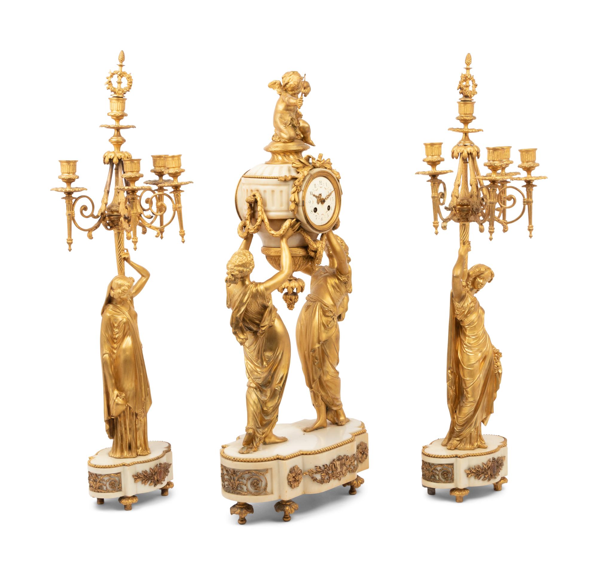 A Louis XVI Style Gilt Bronze and Marble Figural Clock Garniture