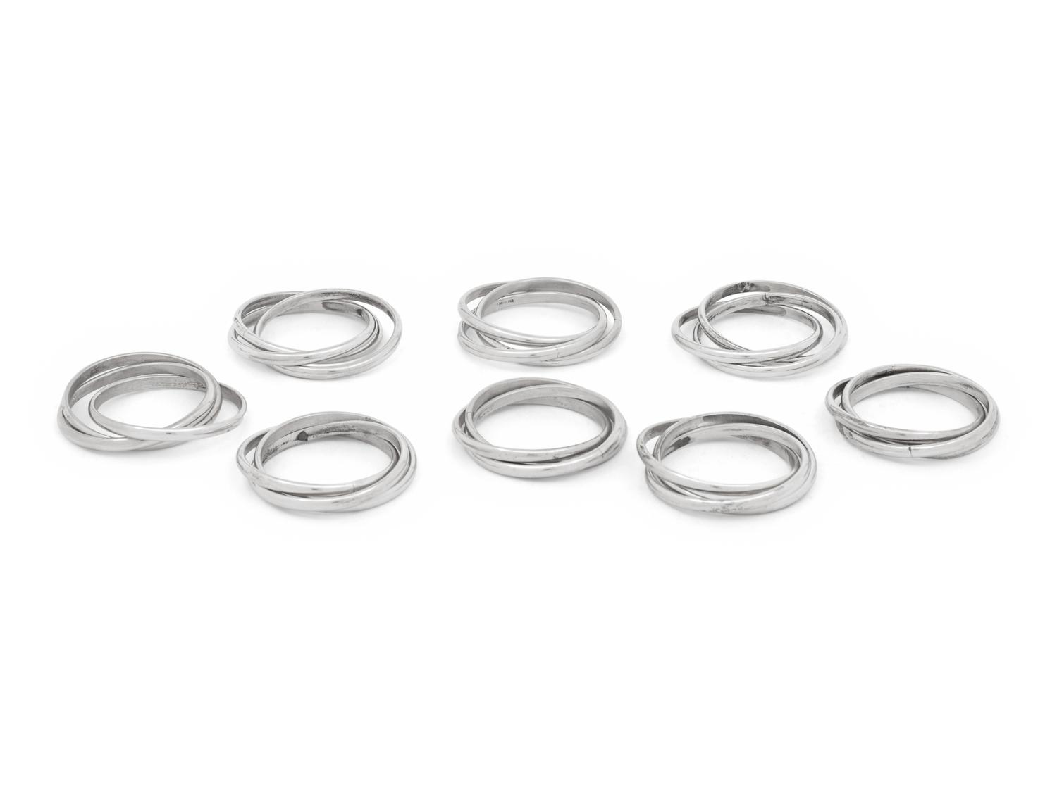 Two Cased Sets of Four Cartier Trinity Silver Napkin Rings