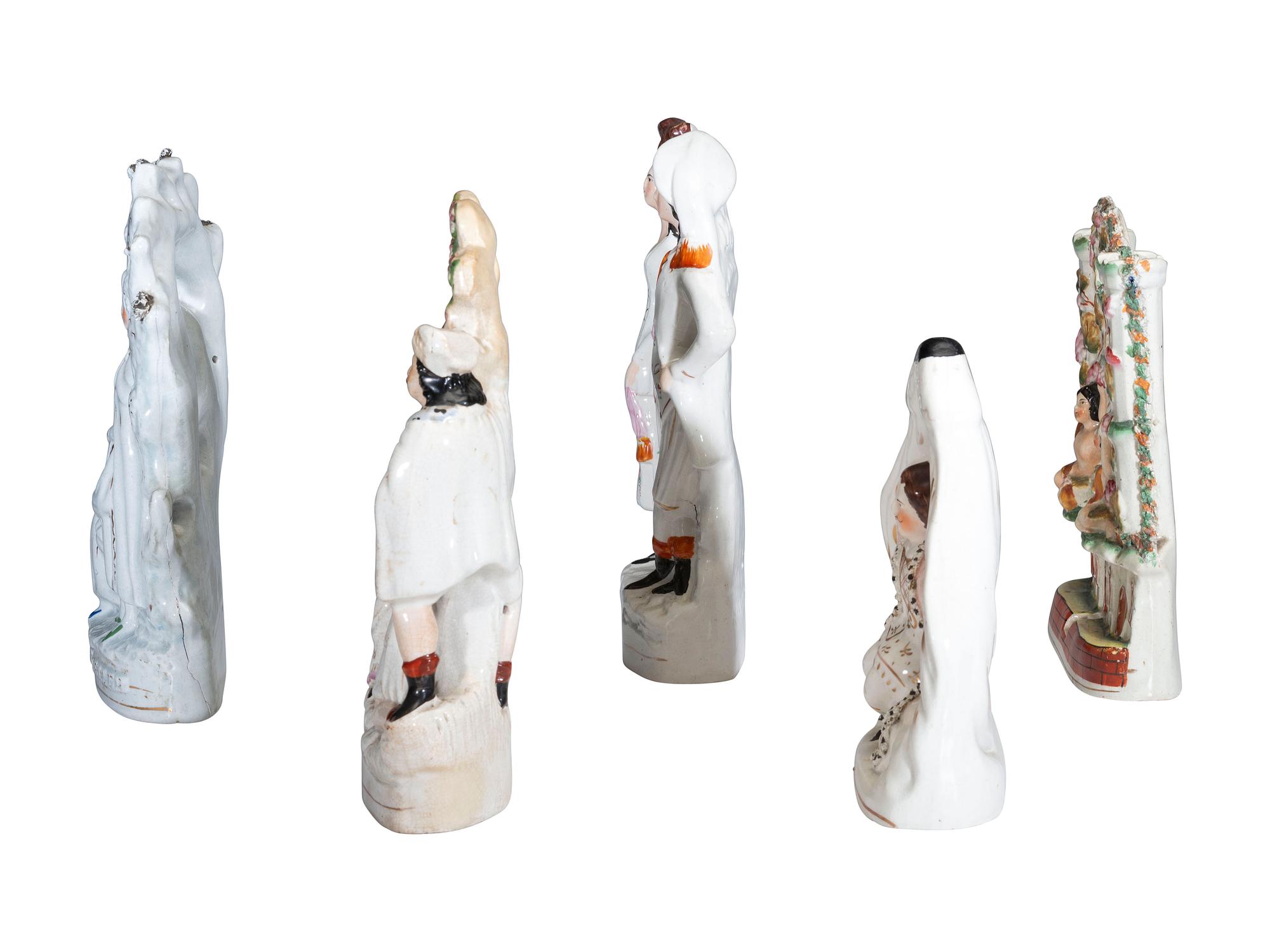 Four Staffordshire Glazed Figures and a Figural Spill Vase