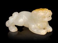 A Russet and White Jade Figure of a Recumbent Beast