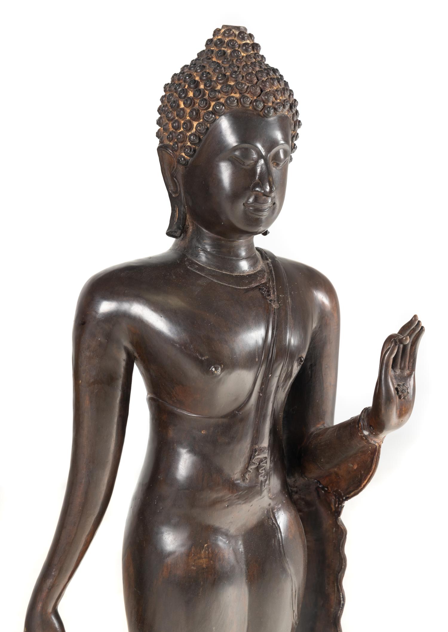 A Large Thai Bronze Figure of Walking Buddha