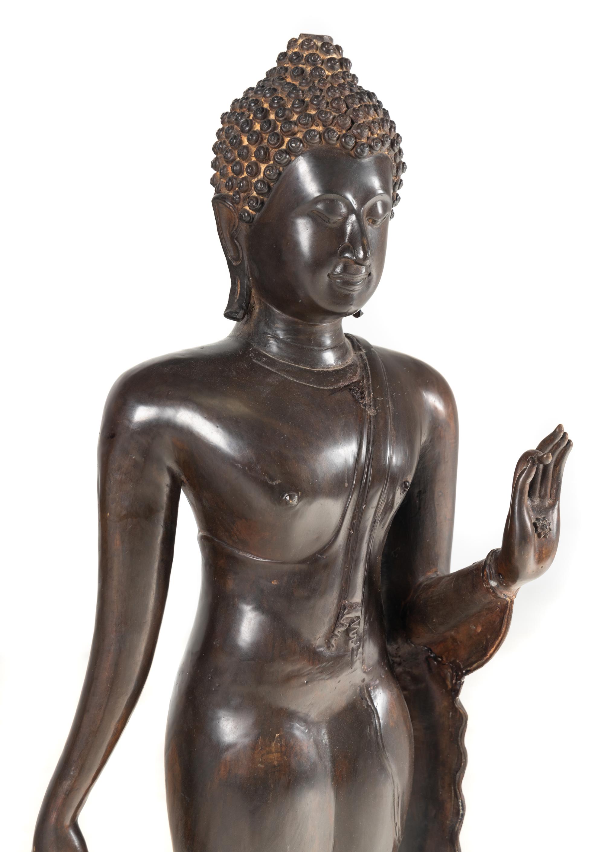 A Large Thai Bronze Figure of Walking Buddha