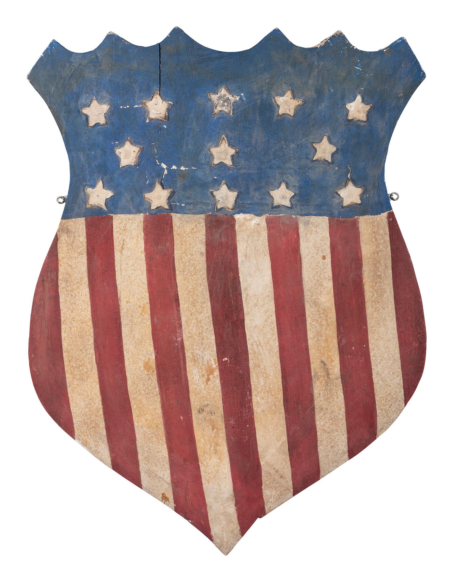 A Folk Art Carved and Painted Shield Form Flag
